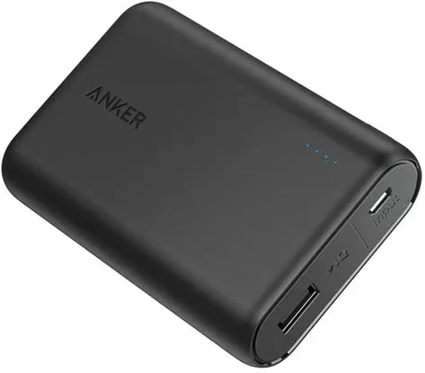 A black Anker PowerCore 10000 power bank with four blue charge lights, a USB-A port and a micro-USB port